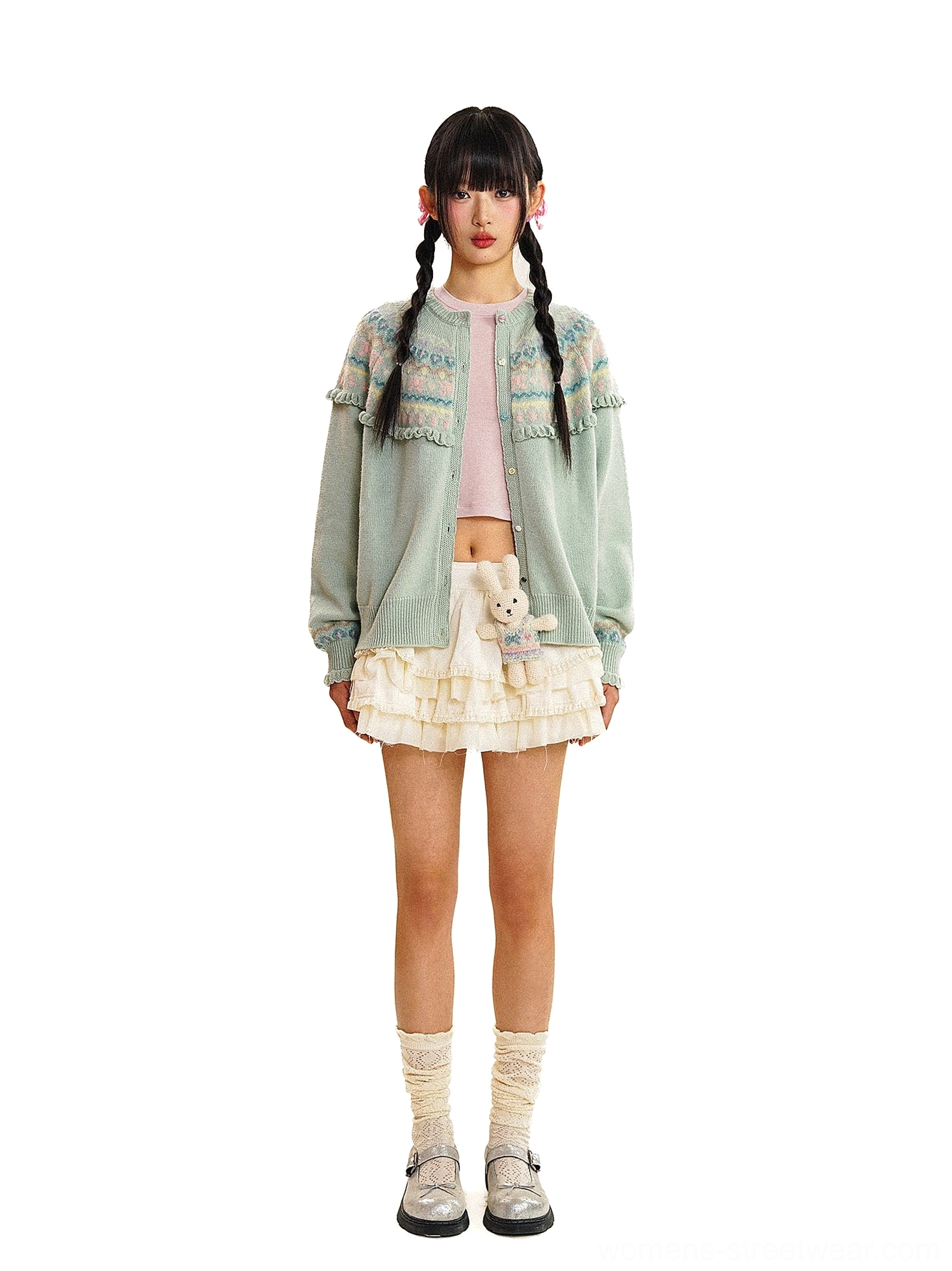 Mint green vintage Fair Isle fringe knit cardigan styled with a pink crop top, ruffled white mini skirt, crew socks, and loafers