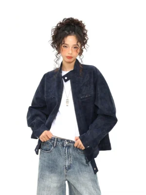 Dark blue vintage faux suede zip trucker jacket with stand collar styled with white tee and wide leg jeans front view
