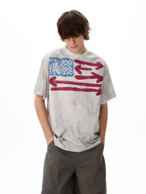 Male model wearing a heather grey vintage flag graphic oversized T-shirt with dark grey cargo shorts in a front streetwear outfit view