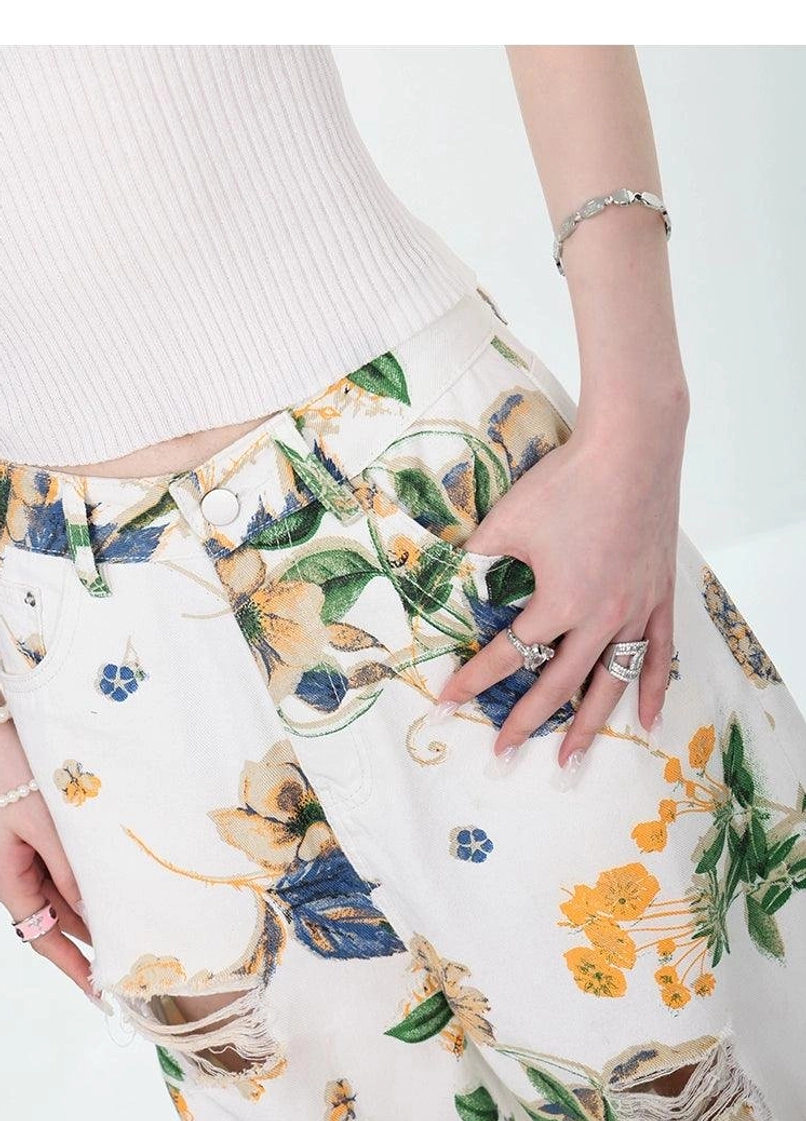 Vintage floral wide-leg denim pants with distressed cut-outs and high-waisted streetwear fit