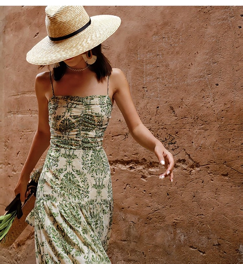 Close-up of vintage green floral maxi dress with square neckline slim straps and softly ruched bust