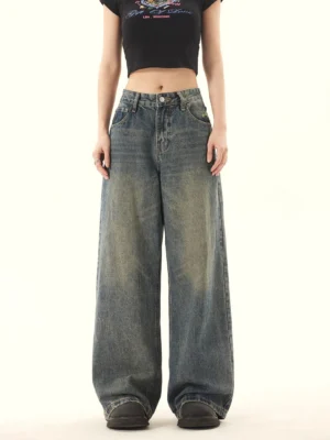 Front view of vintage high-rise wide-leg jeans in faded blue distressed denim with a relaxed streetwear silhouette