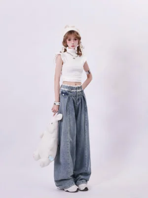 Three-quarter side view of high-waisted faded blue palazzo denim jeans with front pleats and lace-trimmed waistband