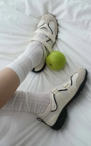 Vintage-inspired Mary Jane casual sneakers worn with white crew socks, featuring adjustable velcro straps and a low-profile streetwear silhouette