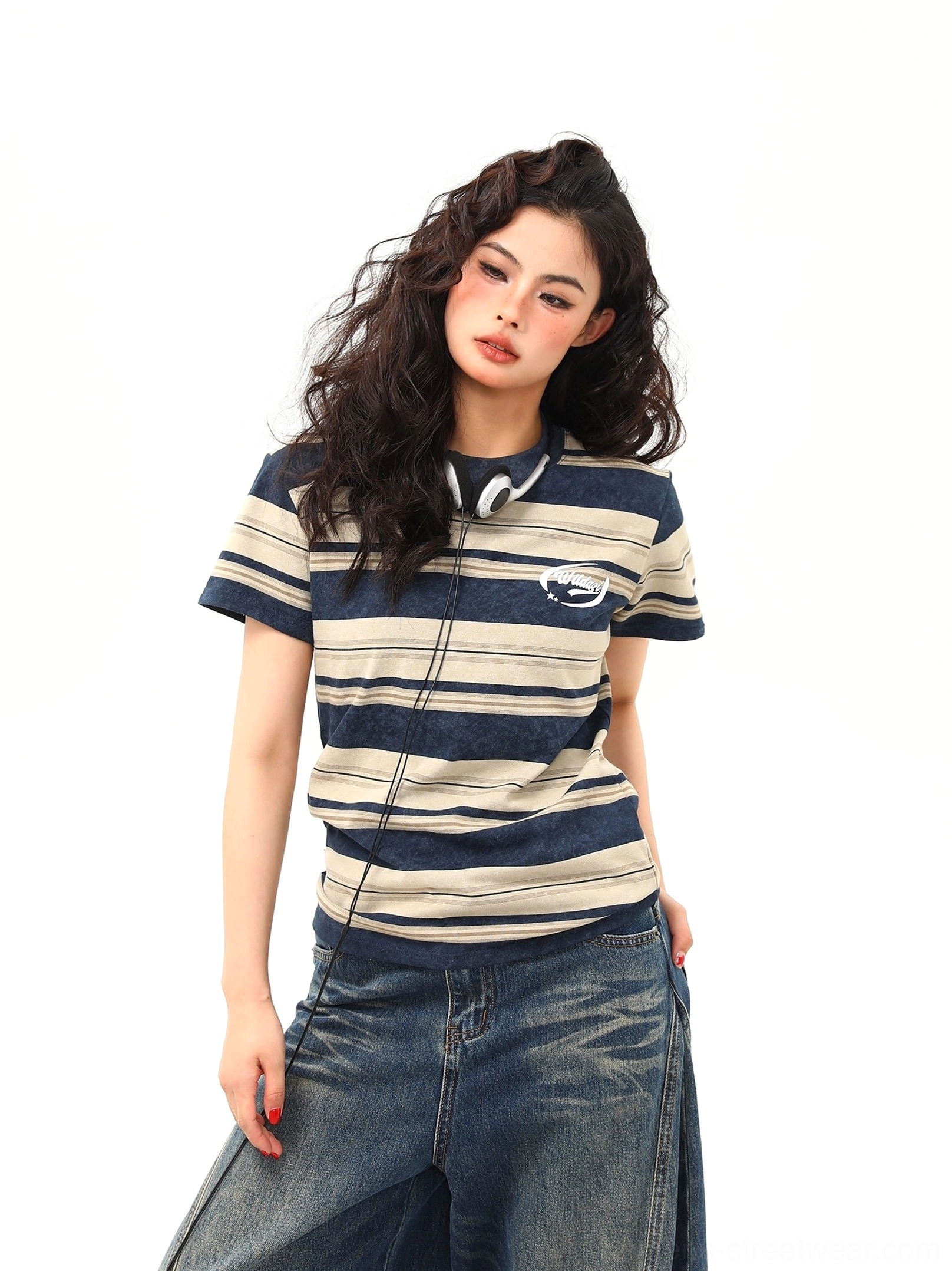 Close front view of vintage navy stripe crewneck T-shirt featuring mixed-width beige stripes and left chest logo detail