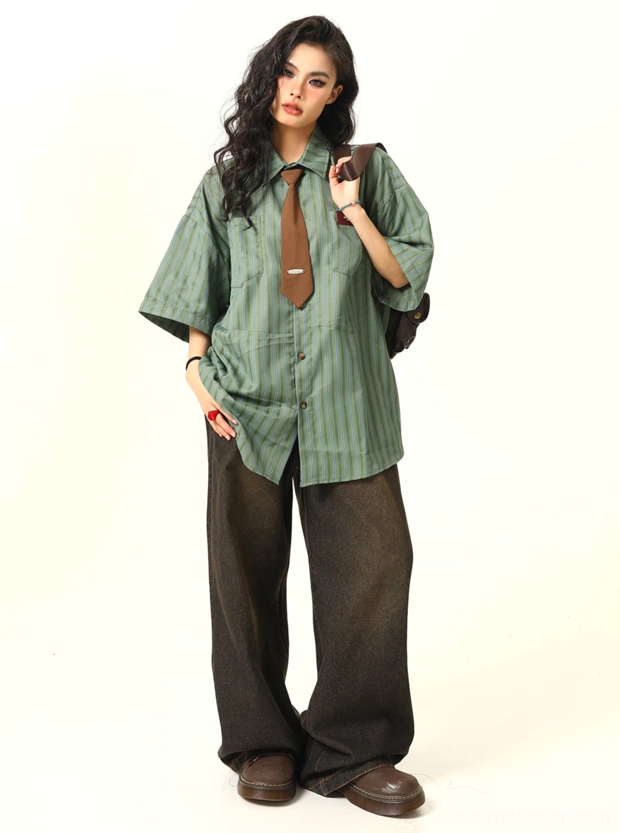 Front view of a vintage oversized striped short sleeve shirt with button closure, decorative chest patch, and coordinating tie