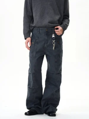 Dark grey vintage panel seam wide-leg cargo pants with flap pockets and metal hanging accessory styled with a grey knit sweater