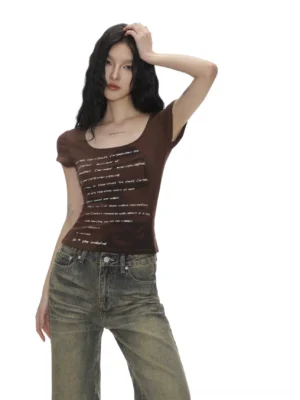 Coffee brown vintage portrait text print scoop neck baby tee styled with washed blue jeans in a three-quarter front model view