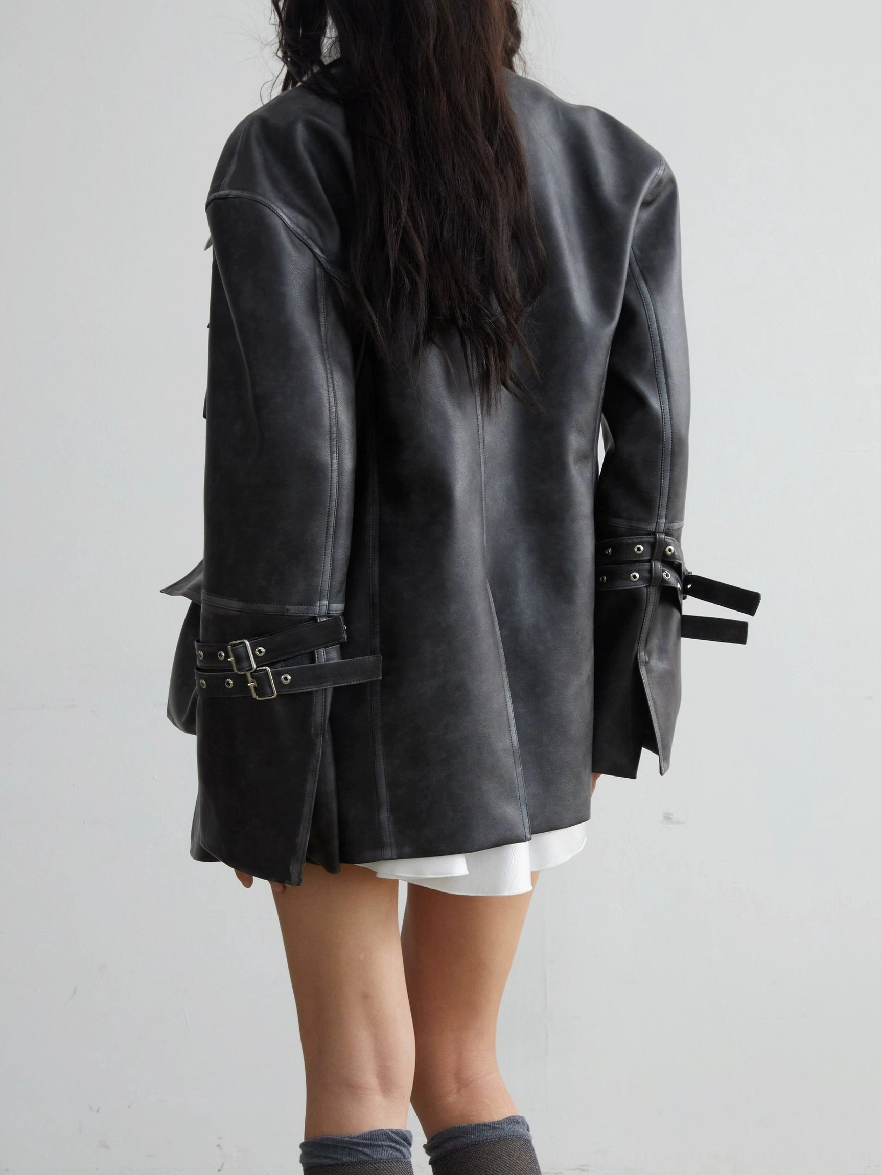 Vintage PU leather utility jacket with 3D cargo pockets, oversized streetwear silhouette, distressed dark-grey finish, and buckle cuffs