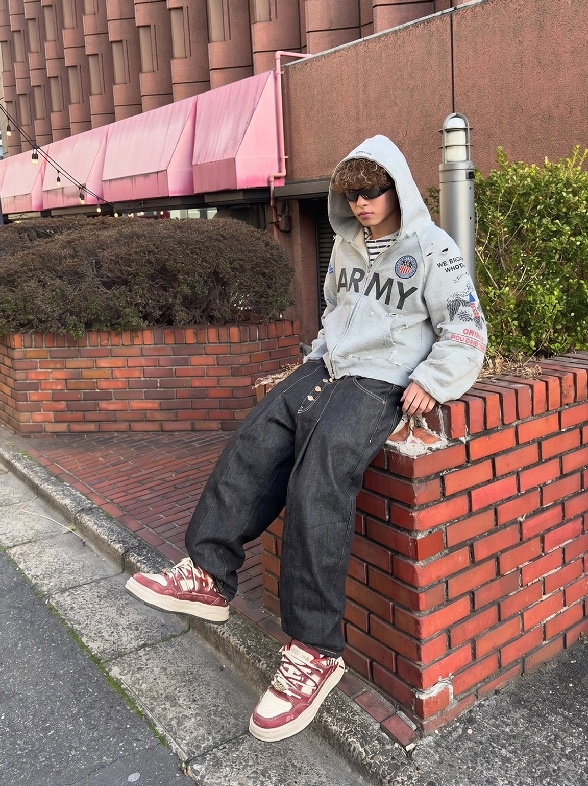 Vintage washed denim platform sneakers styled with an oversized graphic hoodie and baggy black jeans in an urban streetwear outfit
