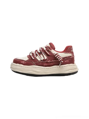 Vintage washed denim platform sneakers with distressed upper, cream chunky outsole, and contrast lace-up stitching shown in a side product view