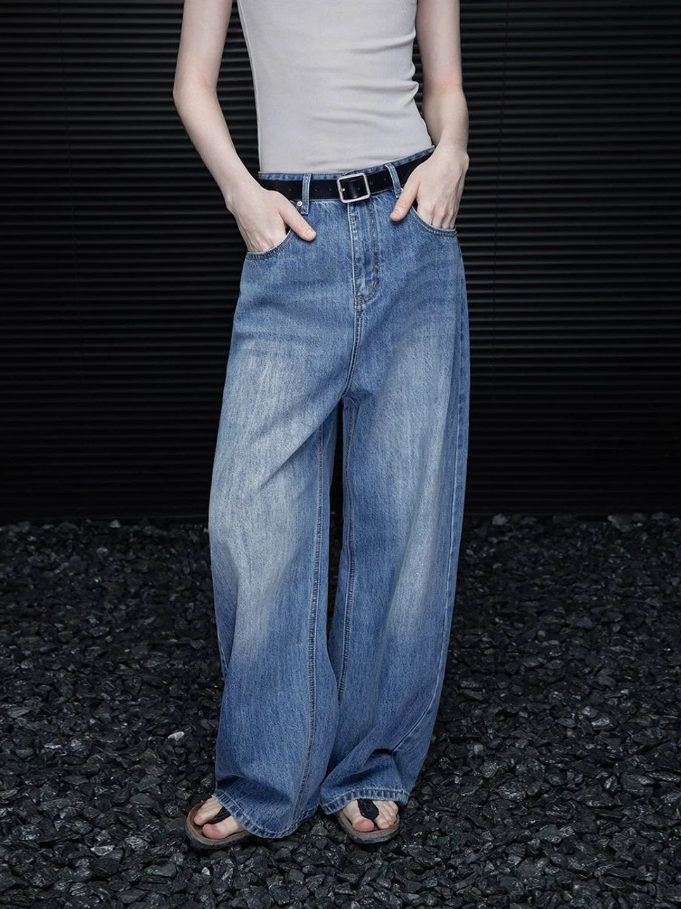 Front full body view of women’s washed blue vintage barrel leg jeans with faded denim wash and relaxed full length fit