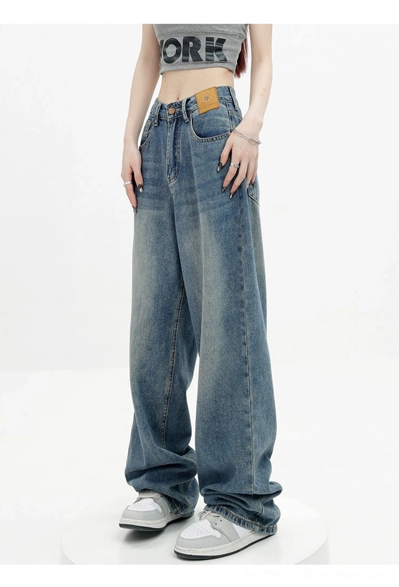Vintage wash high-waist loose straight-leg floor-length jeans angled front view showing faded blue denim