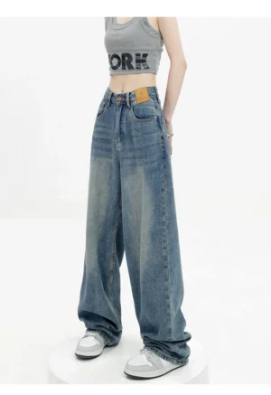 Vintage wash high-waist loose straight-leg floor-length jeans front three-quarter view with sneakers