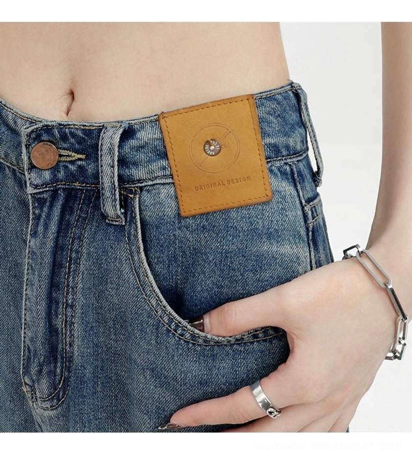 Vintage wash high-waist loose straight-leg jeans close-up of waistband button pocket and leather patch