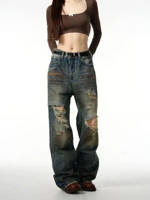 Front view of vintage washed blue baggy ripped denim jeans with oversized wide-leg fit and distressed knee details