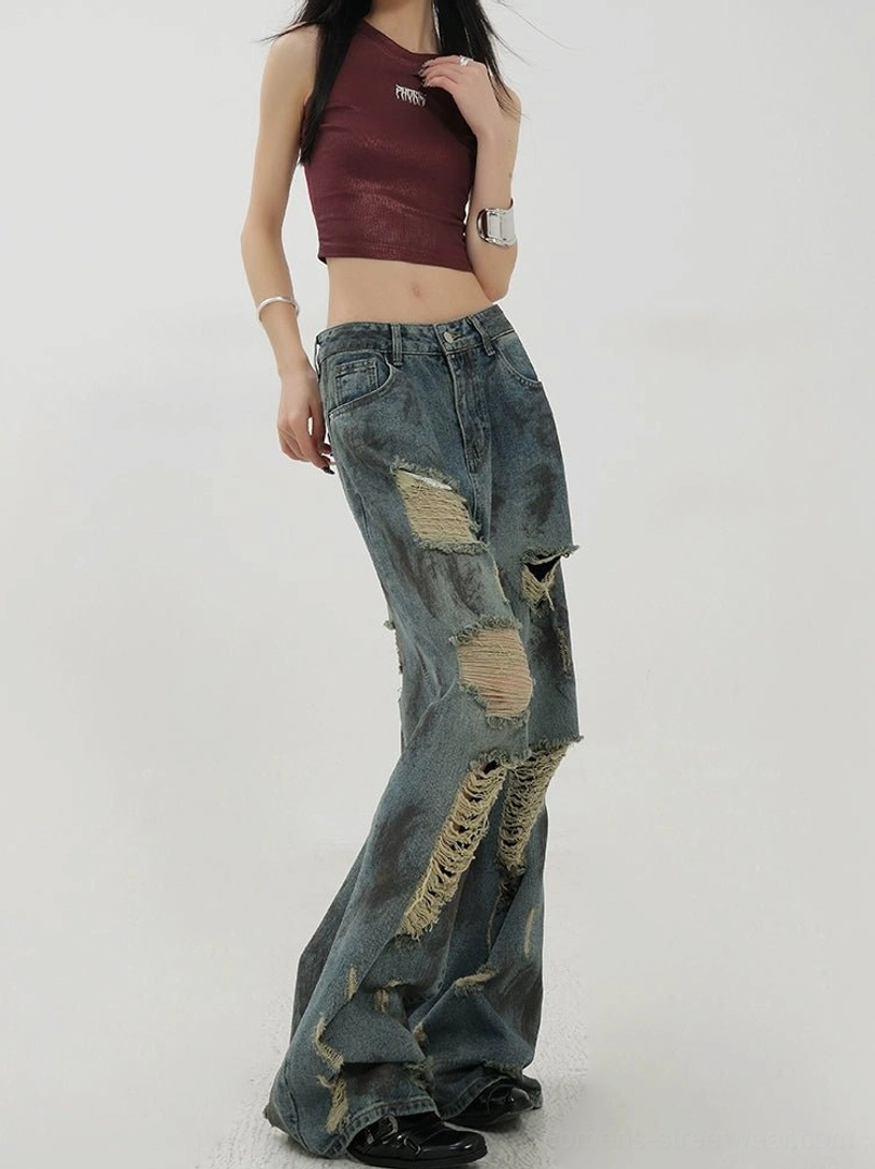 Rear side view of vintage washed blue wide-leg jeans with ripped rear thigh details and relaxed streetwear fit