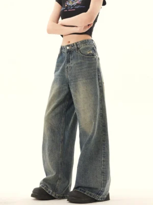Three-quarter view of washed blue vintage wide-leg denim jeans showing the high-rise waist and relaxed leg shape