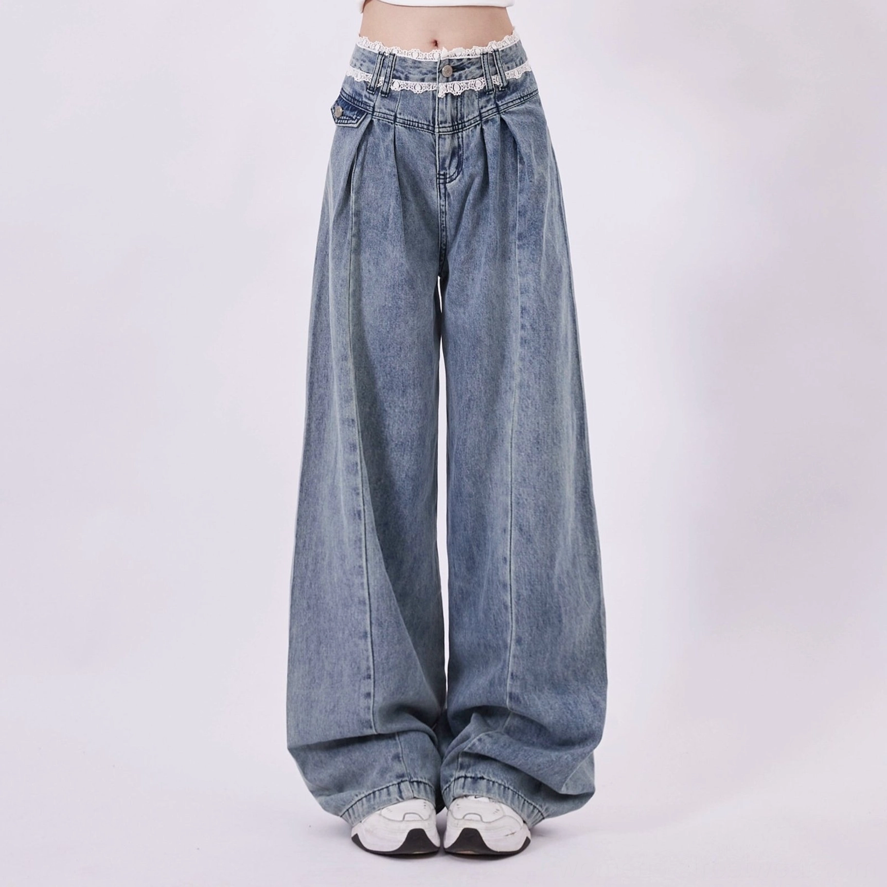 Vintage washed blue wide leg jeans with lace trim waist styled as a Y2K streetwear outfit pairing option