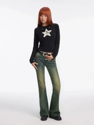 Front view of vintage washed flared jeans styled with a black star print long-sleeve top and flat leather shoes in a casual streetwear outfit