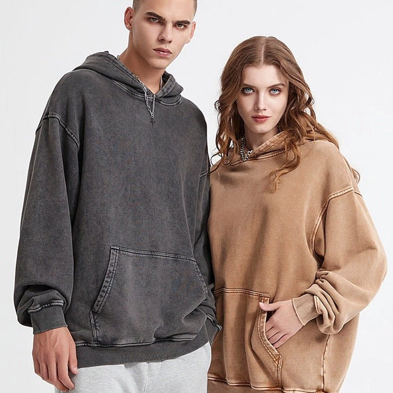 Charcoal gray and tan brown washed oversized hoodies styled as casual vintage-inspired streetwear outfits