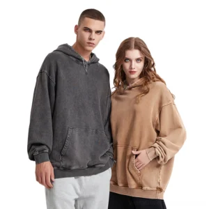 Charcoal gray and tan brown vintage washed oversized hoodies worn by models in a relaxed Seoul streetwear studio look
