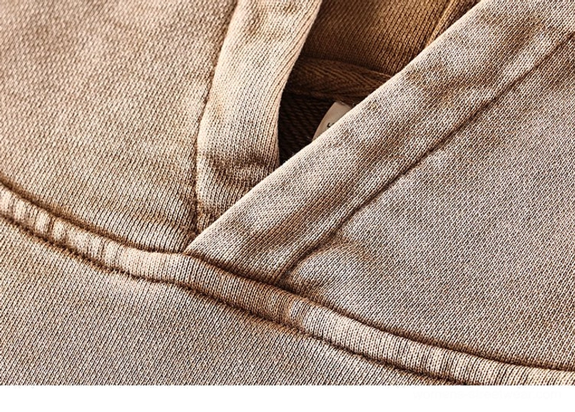 Close-up of reinforced kangaroo pocket on tan brown vintage washed oversized streetwear hoodie