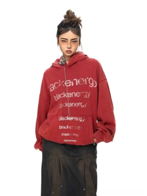 Front view of a vintage washed red oversized logo hoodie with repeated blackenergy lettering, drawstring hood, kangaroo pocket, and relaxed Korean streetwear fit