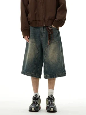 Front full-body view of blue vintage wide-leg denim Bermuda shorts with relaxed fit, oversized patch pockets, washed denim finish, and streetwear styling