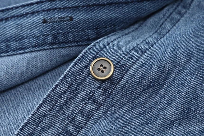 Vintage style women's dark blue denim shirt jacket with button closure, relaxed proportions, and easy oversized layering