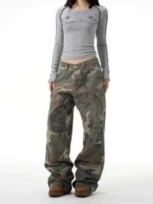 Female model wearing vintage woodland camo baggy streetwear cargo pants in a full front studio view