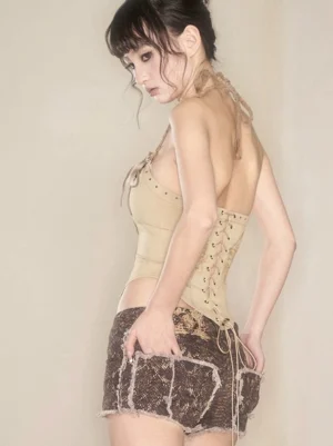 Rear side view of Viper Fringe Distressed Snake Print Denim Hot Shorts styled with a lace-up corset top