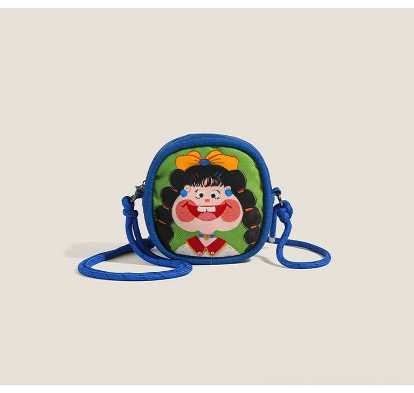 Front view of a vivid blue cartoon character mini crossbody bag with rounded silhouette and rope strap