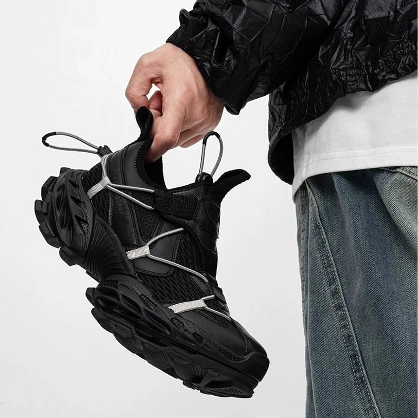 All black techwear sneakers with breathable mesh upper, reflective lace-style accents, streamlined chunky profile, elastic opening, and rugged lug sole styled for Korean streetwear