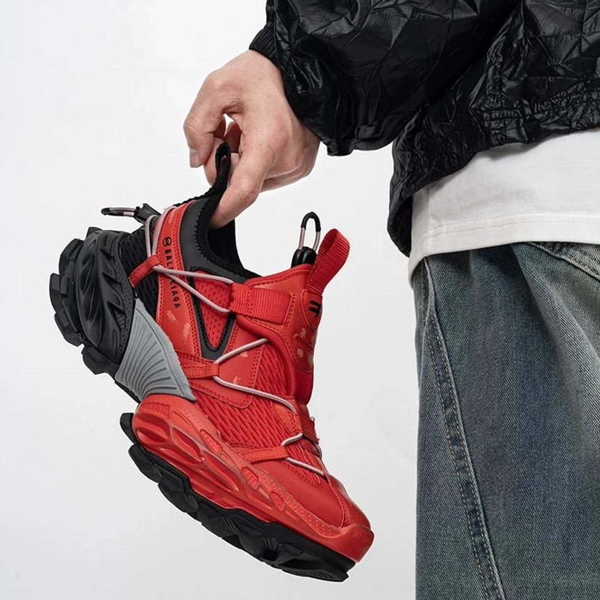 Red black and grey tech trail sneakers with breathable mesh vamp, bold red color blocking, crossed webbing straps, side buckle details, and durable outdoor-inspired anti-slip rubber outsole