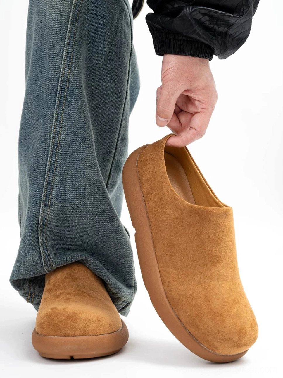 Warm tan suede backless mule clogs styled with baggy blue jeans, showing the rounded toe, soft matte texture, and comfortable thick streetwear outsole