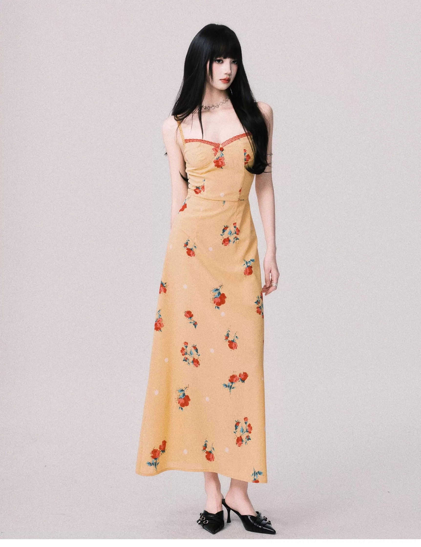 Warm yellow floral sweetheart maxi dress shown from the right side with a softly draped floor length skirt