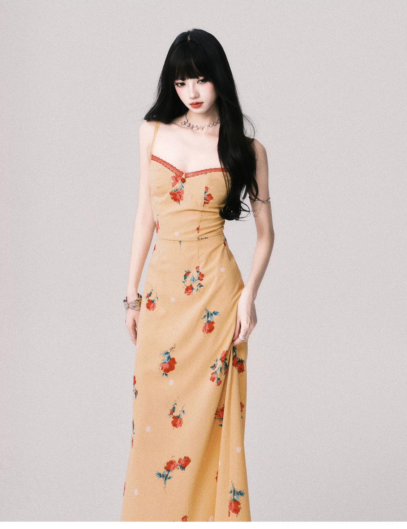Warm yellow floral maxi dress with fitted bodice and side slit shown in a left three quarter streetwear styling view