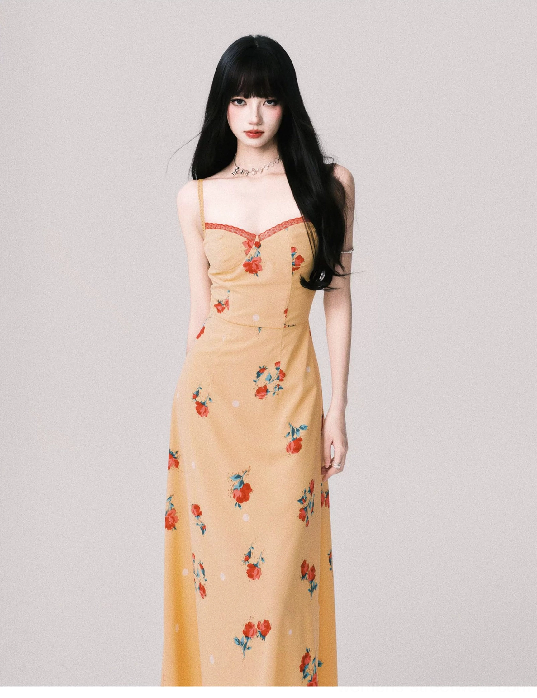 Close full view of a warm yellow floral sweetheart maxi dress showing red neckline trim fitted waist and botanical print