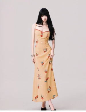 Warm yellow floral camisole maxi dress with red trimmed sweetheart neckline and fitted waist shown in a full front studio view