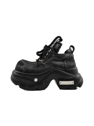 Washed black denim chunky platform sneakers side three quarter view with layered panels and thick lug sole