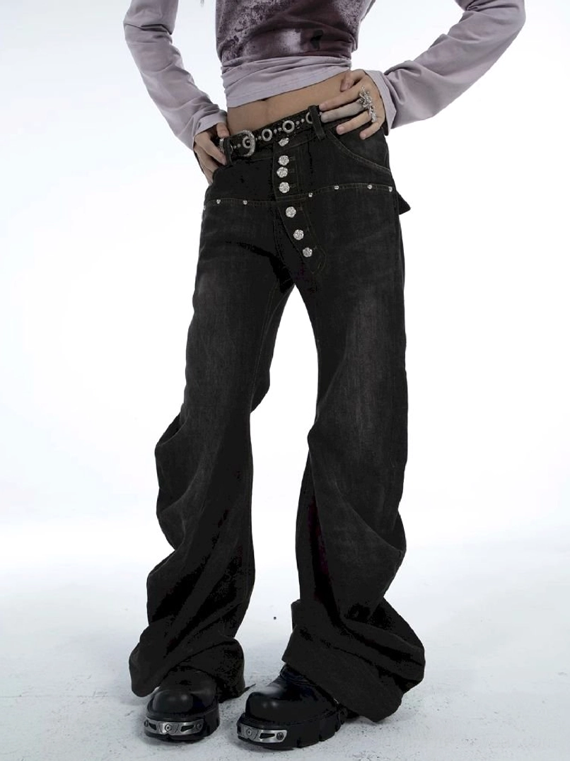 Close front detail of washed black low-rise flare jeans with statement silver multi-button fly and studded waistband