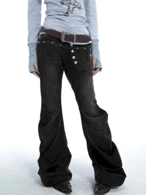 Low-angle front view of washed black multi-button low-rise flare jeans with silver hardware and brown belt