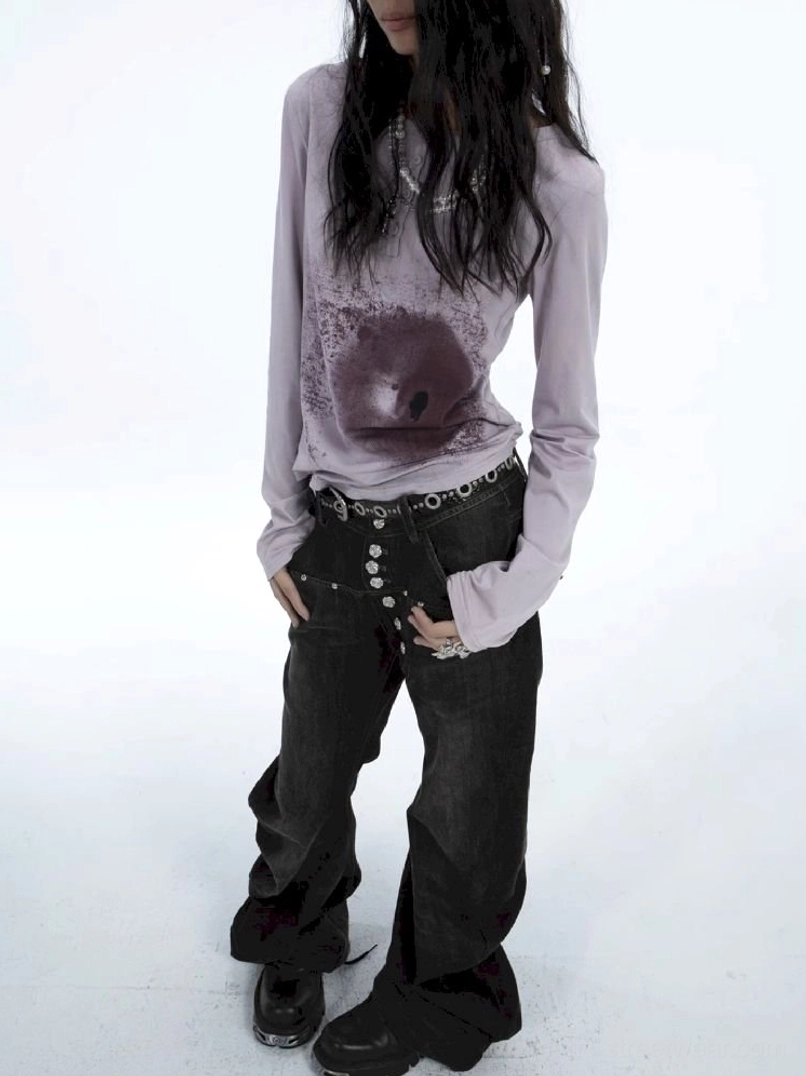Side-back full-body view of washed black low-rise flare jeans with dramatic wide flared silhouette