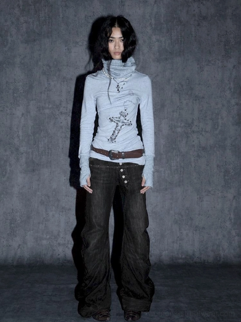 Front studio view of washed black low-rise flare jeans featuring exposed silver multi-button fly detail