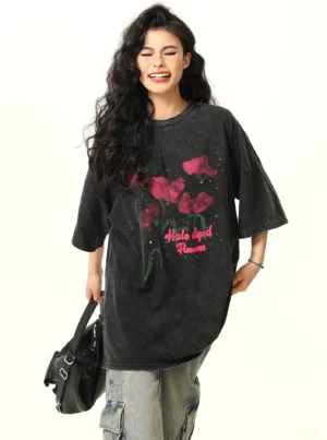 Back three-quarter view of washed black oversized floral graphic streetwear T-shirt with wide leg jeans