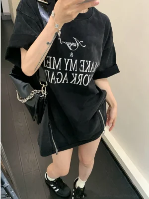 Washed black oversized slogan tee styled with white socks sneakers and chain shoulder bag in a streetwear outfit