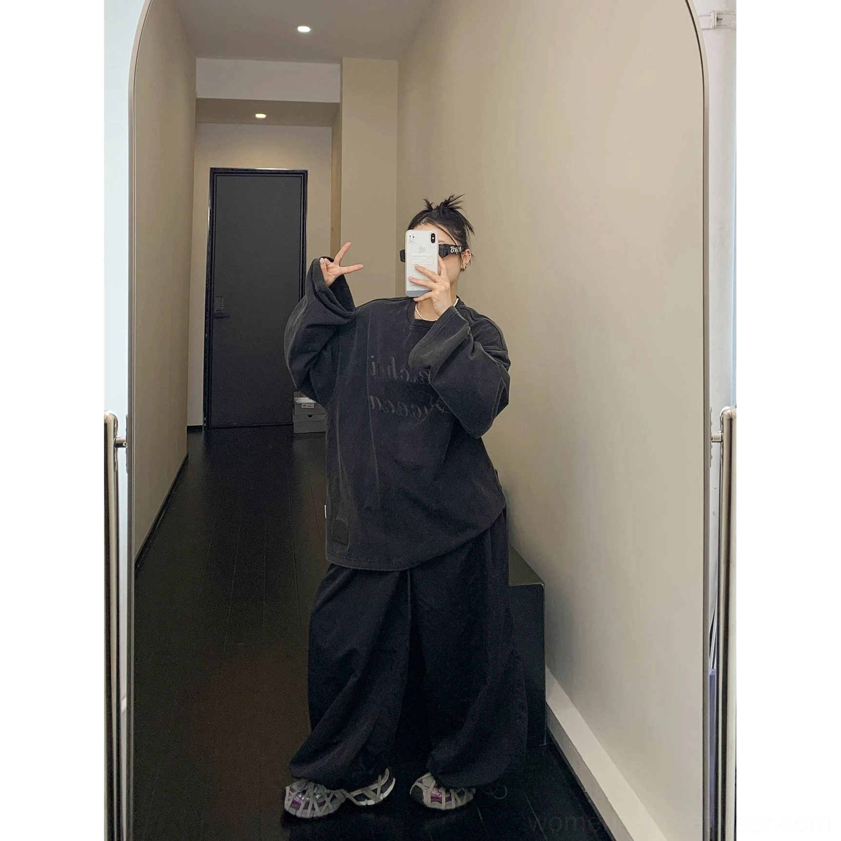 Full-length back view of a coordinated washed black streetwear outfit with oversized fleece sweatshirt and wide-leg trousers