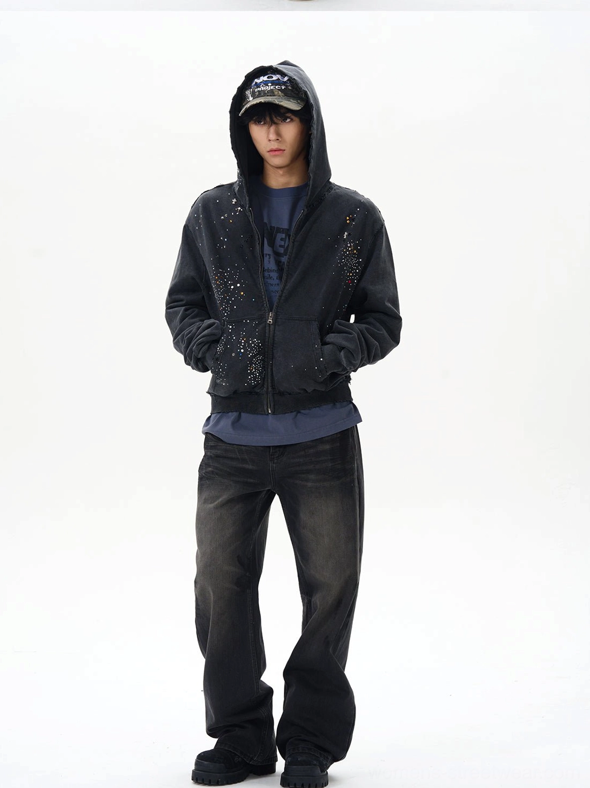 Front view of washed black straight loose jeans styled with a dark rhinestone zip-up hoodie and classic five-pocket denim construction