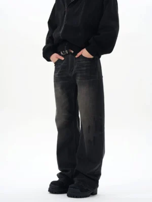 Three-quarter front view of washed black straight loose jeans showing relaxed leg fit, belt loops, and dark faded denim finish